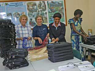 Mrs. S. Stills and Mrs. M. Jacobs helping the TATCOT staff preparing the bags